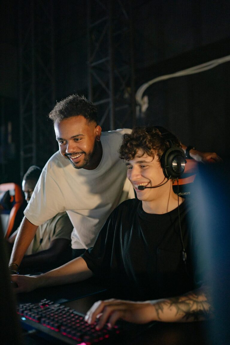 Two young men enjoying an intense esports tournament indoors.